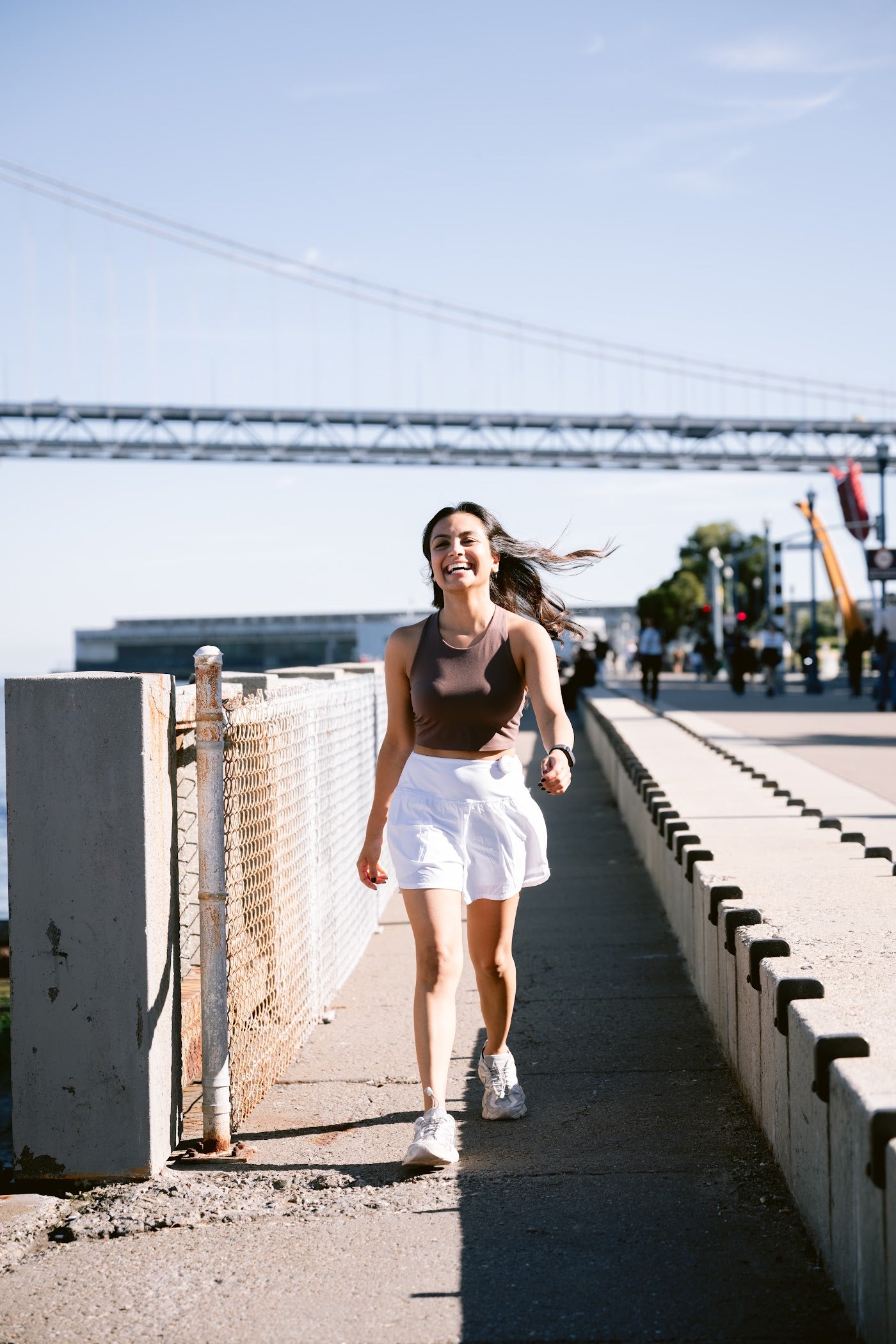 Woman out walking alone at the waterfront with the Birdie Disc