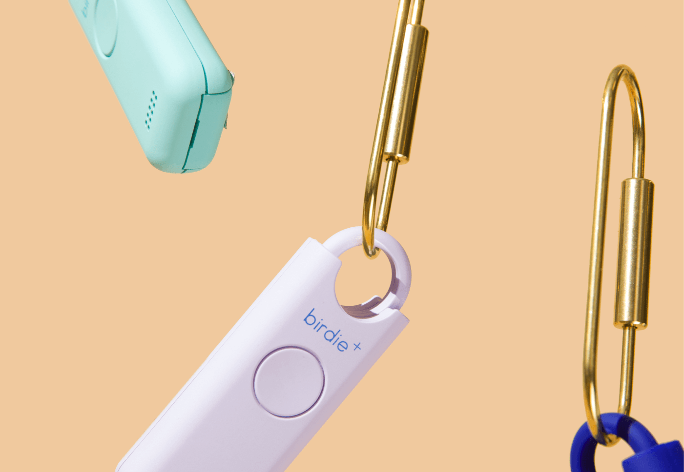 Floating personal safety alarms on a beige background.